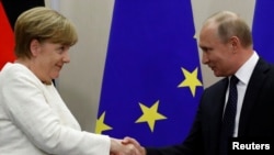 Ruski predsednik Vladimir Putin i nemačka kancelarka Angela Merkel rukuju se nakon zajedničke pres konferencije u Sočiju, Rusija, 18. maja 2018.