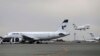 FILE - In this Feb. 7, 2016, photo, an Iranian Mahan Air passenger plane takes off as a plane of Iran's national air carrier Iran Air, left, is parked at Mehrabad airport in Tehran, Iran.