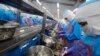 FILE - Workers peel shrimp at the Thai Union factory in Samut Sakhon, Thailand. 