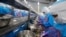 FILE - Workers peel shrimp at the Thai Union factory in Samut Sakhon, Thailand. 