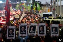 Protesters march to the presidential office after a candlelight vigil against South Korean President Yoon Suk Yeol in Seoul, South Korea, Dec. 5, 2024.