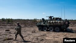 FILE - A U.S. Army soldier and Stryker armored vehicle take part in the "Arrow 16" exercise with the Finnish Army in Niinisalo, Finland, May 4, 2016. U.S. troops are using the Stryker vehicle while offering support near Manbij, Syria, March 6, 2017. 
