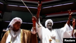 FILE - Delegates affiliated to Sudan’s Rapid Support Forces react during a meeting for the planned signing, later postponed, of a political charter that would provide for a “Government of Peace and Unity” to govern the area the force controls in Nairobi, Kenya, Feb. 18, 2025.