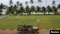 FILE - Sailors sit on a truck at the Cambodian Ream Naval Base in Sihanoukville, Cambodia, July 26, 2019. 