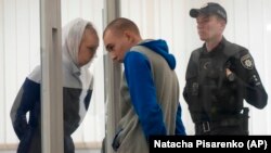 Vadim Shishimarin (21), ruski vojnik, sa prevoditeljicom i stražarom. Shishimarin je 23. maja 2022. osuđen na doživotnu kaznu zatvora zbog ubistva nenaoružanog civila u selu Chupakhivka.