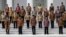 Indonesian President Joko Widodo, front row, center, and his deputy Jusuf Kalla, front row, second right, pose with the newly appointed cabinet ministers after their the inauguration ceremony at the presidential palace in Jakarta, Indonesia, Oct. 27, 2014