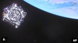 In this photo provided by NASA, the James Webb Space Telescope is separated in space on Dec. 25, 2021. The world will get its first view of a full-color image from the telescope at a White House event Monday.