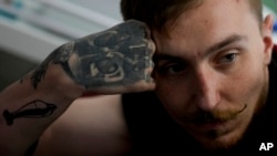 Vladislav Zahorodnii looks on during an interview with The Associated Press at a clinic in Kyiv, Ukraine, Friday, June 17, 2022. Zahorodnii was evacuated from Azovstal by helicopter on March 31, after three failed earlier attempts.