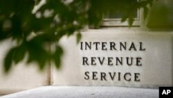FILE - The sign outside the Internal Revenue Service building is seen. May 4, 2021, in Washington. 
