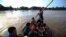 FILE - Central American migrants cross into Mexico from Guatemala, near Ciudad Hidalgo, Mexico, June 4, 2019. The migrants walked over the bridge and waited to register at a Mexican immigration office.