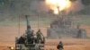 FILE - Taiwan's military fire artillery from self-propelled Howitzers during the annual Han Kuang exercises in Hsinchu, northeastern Taiwan, Sept. 10, 2015. 