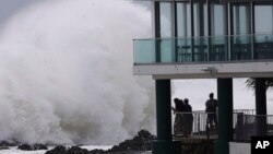 People watch as huge swells hit the beaches on the Gold Coast, Australia, March 6, 2025.