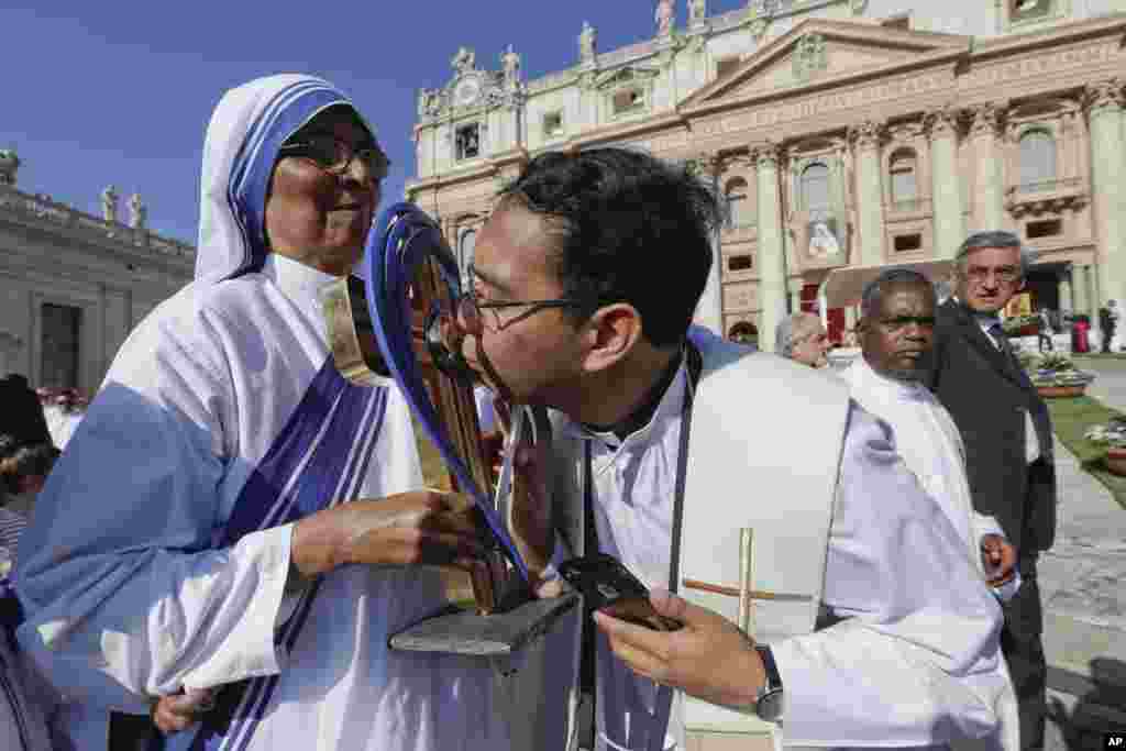 A priest kisses the relics of Mother Teresa prior to the start of a Mass celebrated by Pope Francis where she will be canonized in St. Peter's Square, at the Vatican, Sept. 4, 2016.