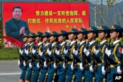 2015年8月22日，中国女兵在练习中走过标语牌