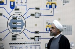 FILE - A handout picture released by the official website of the Iranian President Hassan Rouhani shows him visiting the control room of the Bushehr nuclear power plant in the Gulf port city of Bushehr, Jan. 13, 2015.