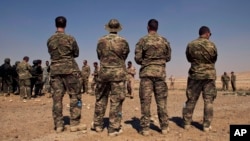 FILE - U.S. special operations forces watch a multinational military exercise in Zarqa, Jordan, in 2013. An additional 250 U.S. special operations troops are heading to Syria to provide expertise to Syrians willing to take on Islamic State, the Pentagon said Monday.