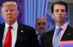 FILE - This photo from Jan. 11, 2017, shows Donald Trump, left, his chief financial officer Allen Weisselberg, center, and his son Donald Trump Jr., right, during a news conference at Trump Tower in New York.