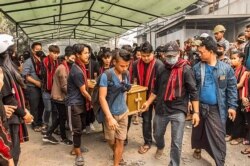 FILE - Pallbearers carry the coffin of a protester who was shot dead on March 28 amid a crackdown by security forces on demonstrations against the military coup, during the funeral in Kale, March 29, 2021, in this picture from Facebook.