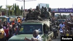 Residents cheer at army soldiers as they celebrate the uprising in Conakry, Guinea, Sept. 5, 2021. 