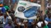 A supporter of Kenyan opposition leader Raila Odinga holds a banner of him with the Swahili words "Father" and "Chairman" at a rally in the Shauri Moyo area of Nairobi, Kenya, Oct. 18, 2017.