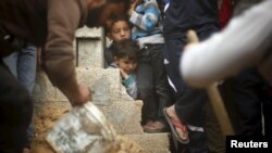 男孩们看着巴勒斯坦兄妹丧生的地方（2016年3月12日）