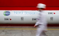 FILE - The logo of the Nord Stream 2 gas pipeline project is seen on a pipe at the Chelyabinsk pipe rolling plant in Chelyabinsk, Russia, Feb. 26, 2020.