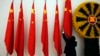 FILE PHOTO - An official adjusts Chinese flags before Chinese Premier Wen Jiabao arrives for the 21st ASEAN (Association of Southeast Asian Nations) and East Asia summits in Phnom Penh November 18, 2012. Southeast Asian nations displayed a rare show of unity on Sunday against China's sweeping maritime claims, calling for the first formal talks with Beijing over a sea dispute that has raised tensions and exposed deep divisions in the region. (Photo: REUTERS/Damir Sagolj)