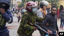 FILE - Kenyan anti-riot police arrest a man during a protest in Nairobi on June 27, 2024.