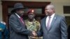 FILE - South Sudanese President Salva Kiir, left, and Vice President Riek Machar shake hands after meetings in Juba, South Sudan, on Oct. 20, 2019, to discuss outstanding issues to a peace deal.