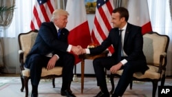 Presiden Amerika Serikat Donald Trump berjabat tangan dengan Presiden Emmanuel Macron dalam pertemuan di Keduataan AS di Brussels, 25 Mei 2017 (Foto: dok). 