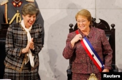 Chile's President Michelle Bachelet smiles next to Senate President Isabel Allende (L), daughter of late former President Salvador Allende.