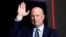 FILE - Former acting Attorney General Matt Whitaker waves as Donald Trump speaks at a caucus night party in Des Moines, Iowa, on Jan. 15, 2024. President-elect Trump on Nov. 20, 2024, announced Whitaker as his choice to be the U.S. ambassador to NATO.