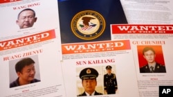 Press materials are displayed on a table of the Justice Department in Washington, May 19, 2014, before Attorney General Eric Holder was to speak at a news conference. 