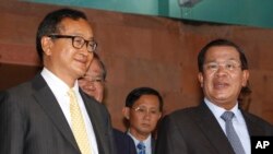 FILE PHOTO - Cambodian Prime Minister Hun Sen, right, talks with the main Opposition Party leader Sam Rainsy, left, of Cambodia National Rescue Party, after their meeting in Senate headquarters in Phnom Penh, Cambodia, Tuesday, July 22, 2012.