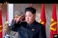 In this image made from video, North Korean leader Kim Jong Un salutes during the ceremony to mark the 70th anniversary of the country's ruling party in Pyongyang, Oct. 10, 2015.