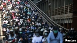 台北街头早高峰时间戴着口罩骑车的市民。（2021年7月13日）