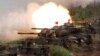 FILE- In this May 25, 2017, file photo, a line of U.S. M60A3 Patton tank fire at targets during the annual Han Kuang exercises on the outlying Penghu Island, Taiwan.