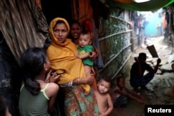 Rohingya refugees are seen outside their makeshift tent in the Kutupalong camp in Cox's Bazar, Bangladesh, Aug. 24, 2018.