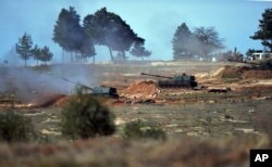 FILE - Turkish artillery fire from the border toward northern Syria, in Kilis, Turkey, Feb. 16, 2016.