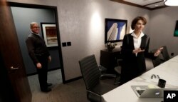 Former Nebraska Lt. Gov. Kim Robak, a Democrat, and her husband, Bill Mueller, a Republican, stand in their office in Lincoln, Nebraska, Jan. 4, 2017.
