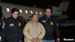 Mexico's top drug lord Joaquin "El Chapo" Guzman is escorted as he arrives at Long Island MacArthur airport in New York, Jan. 19, 2017, following his extradition from Mexico.