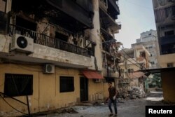 Muškarac prolazi pored oštećene zgrade nakon izraelskih napada, u oblasti Čija u Bejrutu, 5. oktobra 2024.