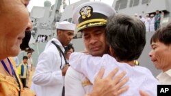 In this photo taken Dec. 3, 2010, U.S. navy officer Michael "Vannak Khem" Misiewicz becomes emotional as he embraces his aunt Samrith Sokha, 72, at Cambodian coastal international see port of Sihanoukville, Cambodia. 