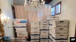 FILE - Boxes of records sit at Trump's Mar-a-Lago estate in Palm Beach, Florida. The federal judge in Florida presiding over the classified documents prosecution of Trump has canceled the May 20 trial date, postponing it indefinitely. (Justice Department via AP)