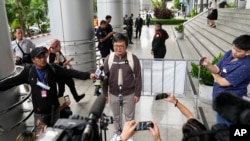 FILE - Thai prominent human rights lawyer Arnon Nampa talks to the media on the arrival at the Criminal court to hear his first verdict in his trial, Sept. 26, 2023. He was convicted of insulting the monarchy and sentenced to four years in prison. 