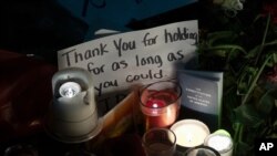 Candles and messages are left on the sidewalk in front of the Supreme Court to honor the late Justice Ruth Bader Ginsburg, in Washington, Sept. 19, 2020.