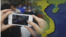 A citizen journalist takes a photo of a map of Vietnam.