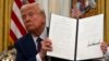 Trump signs executive orders on AI, cryptocurrency and issues more pardons 