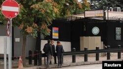 FILE - People are seen in front of the visa application office entrance of the U.S. Embassy in Ankara, Turkey, Oct. 9, 2017. The U.S. suspended all non-immigrant visa services in Turkey Oct 8. and has since resumed only limited services.