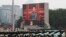 FILE - Chinese President Xi Jinping is seen on a giant screen as he delivers a speech at the event marking the 100th founding anniversary of the Communist Party of China, on Tiananmen Square in Beijing, China, July 1, 2021. 
